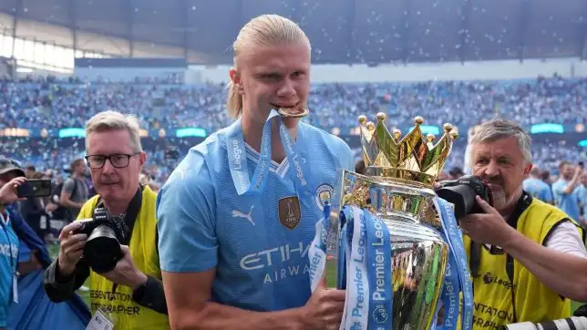 Manchester City's Erling Haaland celebrates with the Premier League trophy after the Premier League match at the Etihad Stadium, Manchester. Picture date: Sunday May 19, 2024.