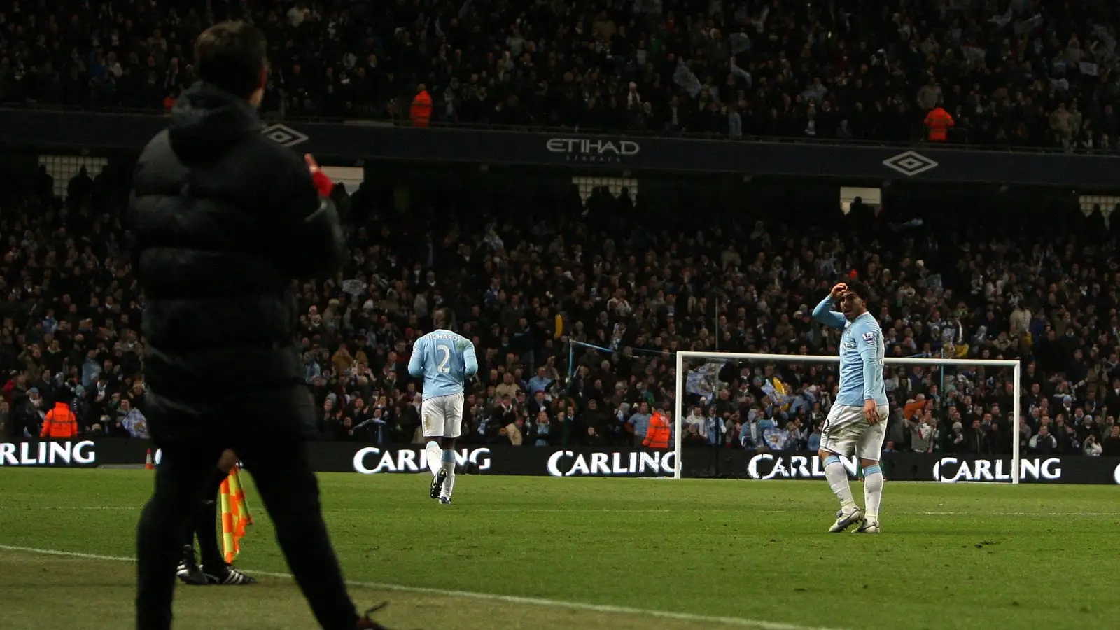 Carlos Tevez and Gary Neville gesture at each other during the League Cup semi-final between Manchester City and Manchester United at Etihad Stadium, Manchester, January 2010.