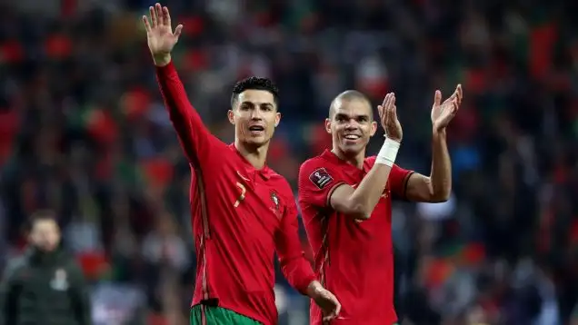 Portugal's forward Cristiano Ronaldo (L) and Pepe celebrate the victory at the end of the 2022 FIFA World Cup Qualifier football match between Portugal and North Macedonia at the Dragao stadium in Porto, Portugal, on March 29, 2022.